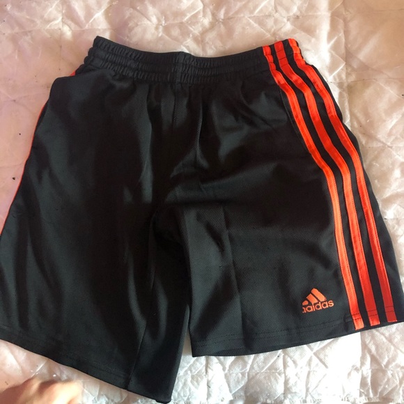 black adidas shorts with red stripes